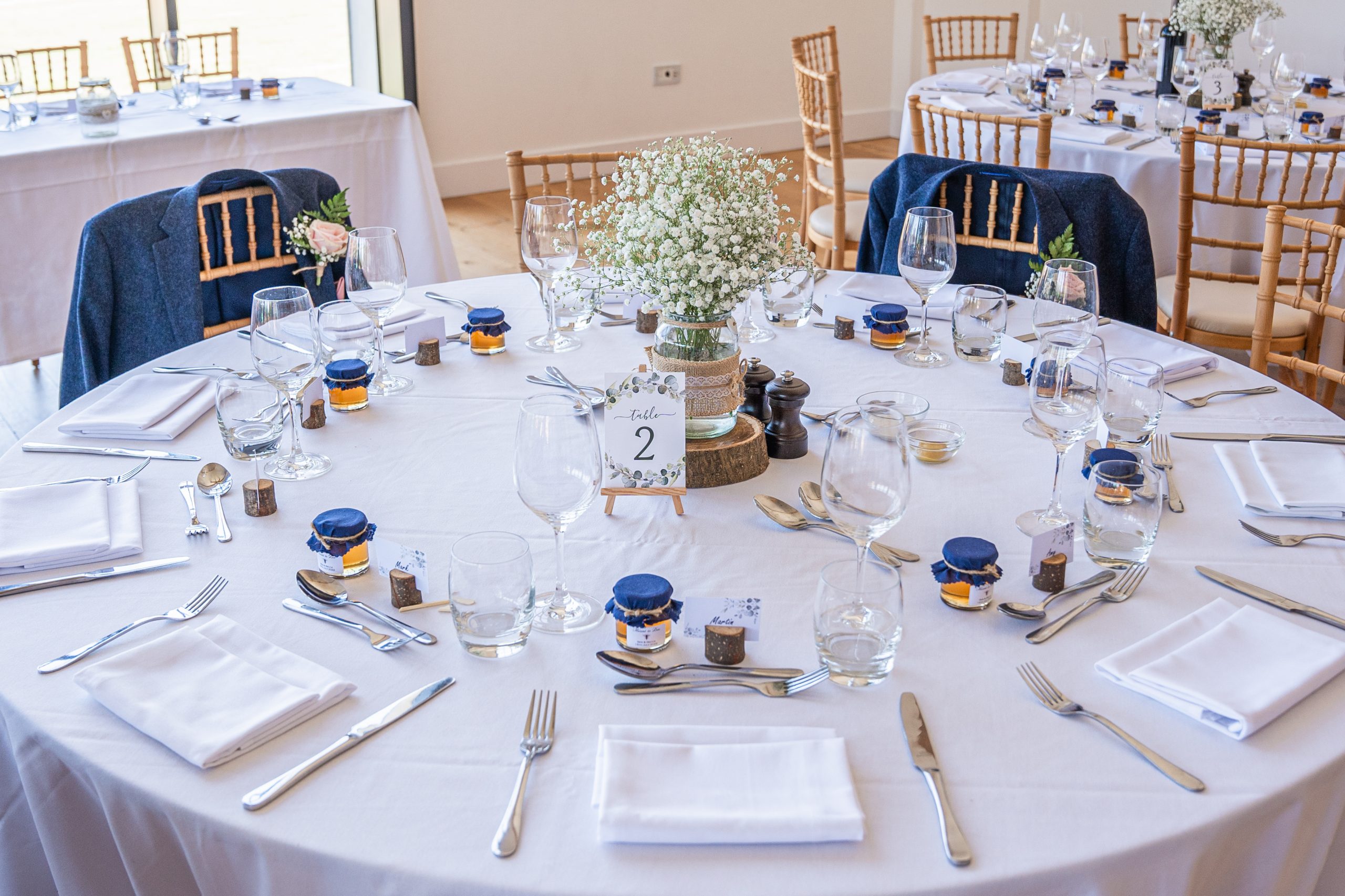 Tables laid with individual pots of local honey for guests favours