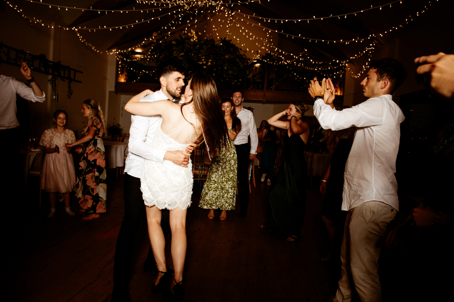 James and Fran dancing under a canopy of sparkling lights, with Fran having changed from her bridal gown into a short beaded dress for the evening.