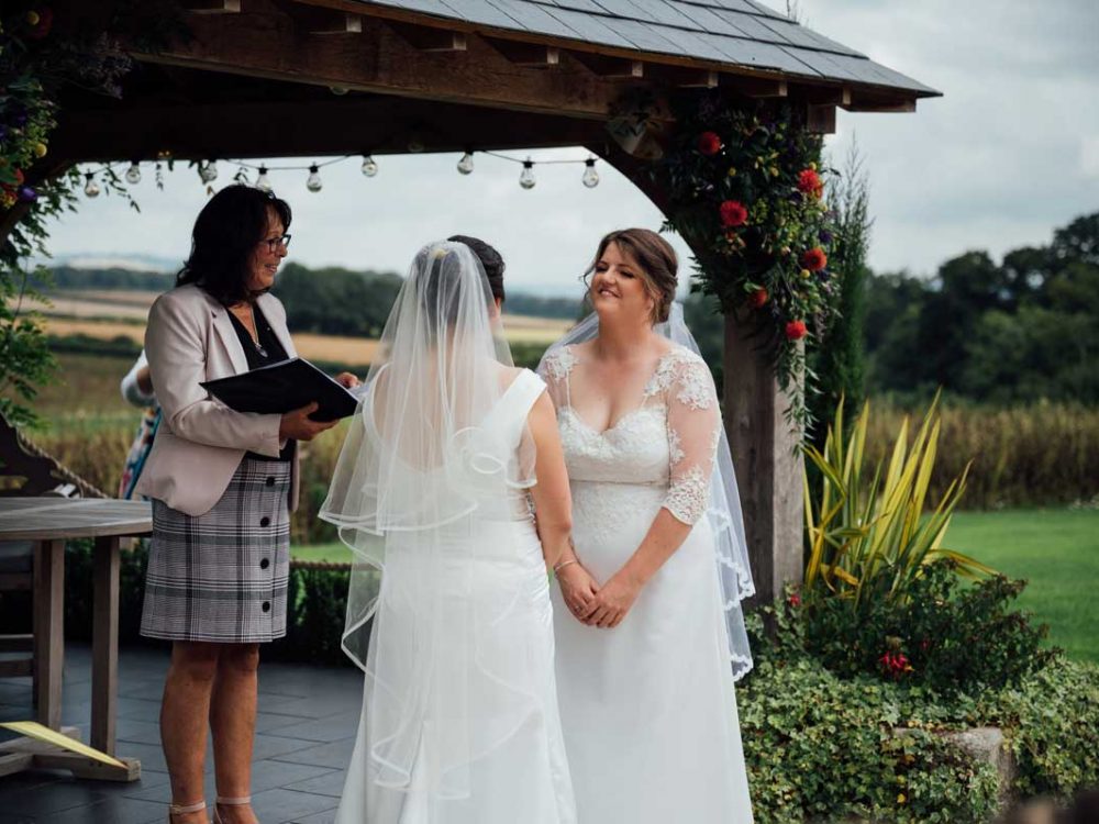 Two brides at outdoor wedding ceremony