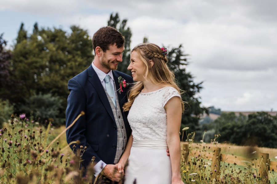 Happy couple in countryside around Harefield Barn wedding venue Devon